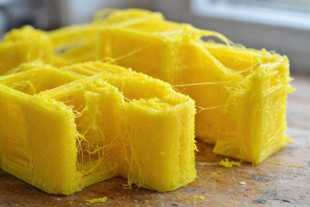The physical result of an Orca Slicer version update extrusion issue on yellow PLA.